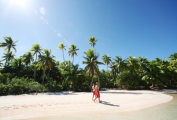 Couple walking on a Polynesian beach